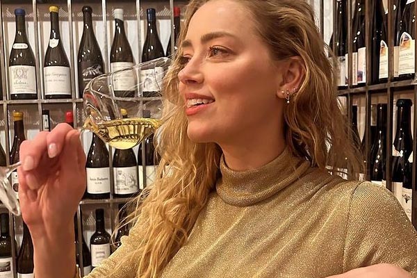 Amber Heard Enjoys Champagne in Uncommon Snapshot During 38th Birthday Celebration